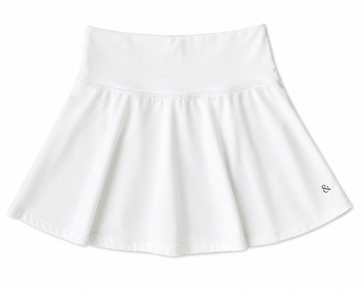 A white athletic tennis skirt with a wide elastic waistband and a small black monogram logo on the lower right hem, shown against a plain white background. The back says Roll for a gameday outfit. People from Alabama know the roll phrase. 