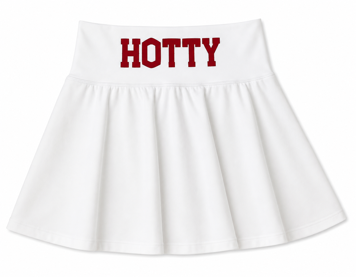 A white pleated skirt with the word 'HOTTY' printed in bold red block letters across the waistband, shown against a plain white background. Made for gameday. It is a Mississippi skirt. 