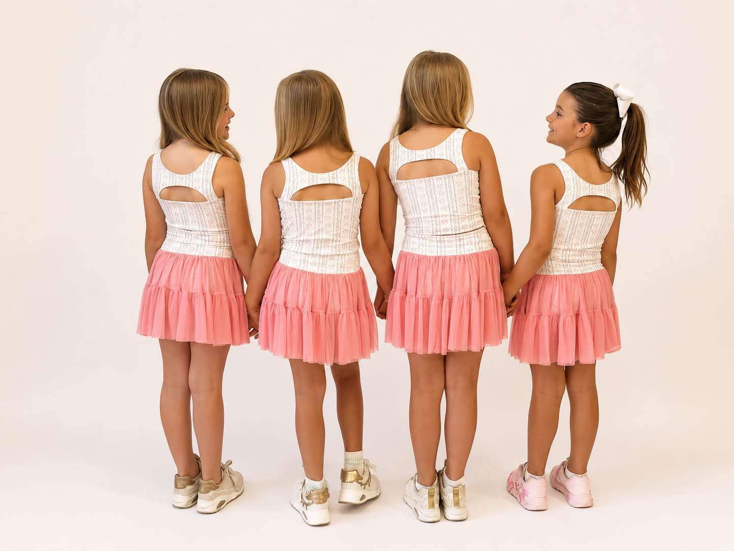Girls in Two-Piece Bow and Pink  Skirt sets with ink skirts overlays and bow pinted detail 