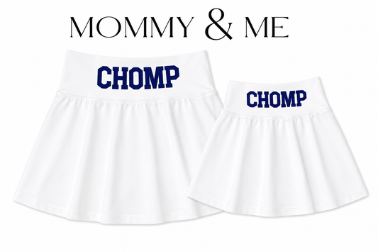 Two white pleated skirts shown on a white background, labeled 'MOMMY & ME' at the top. The larger skirt says 'CHOMP' in blue and the smaller skirt says 'CHOMP' as well. For Florida.