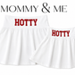 Two white tennis skirts  shown on a white background, one larger and one smaller, mommy and me both with the word 'HOTTY' printed in red across the waistband. Above the products, the text 'MOMMY & ME' appears in black. Made for Mississippi. 